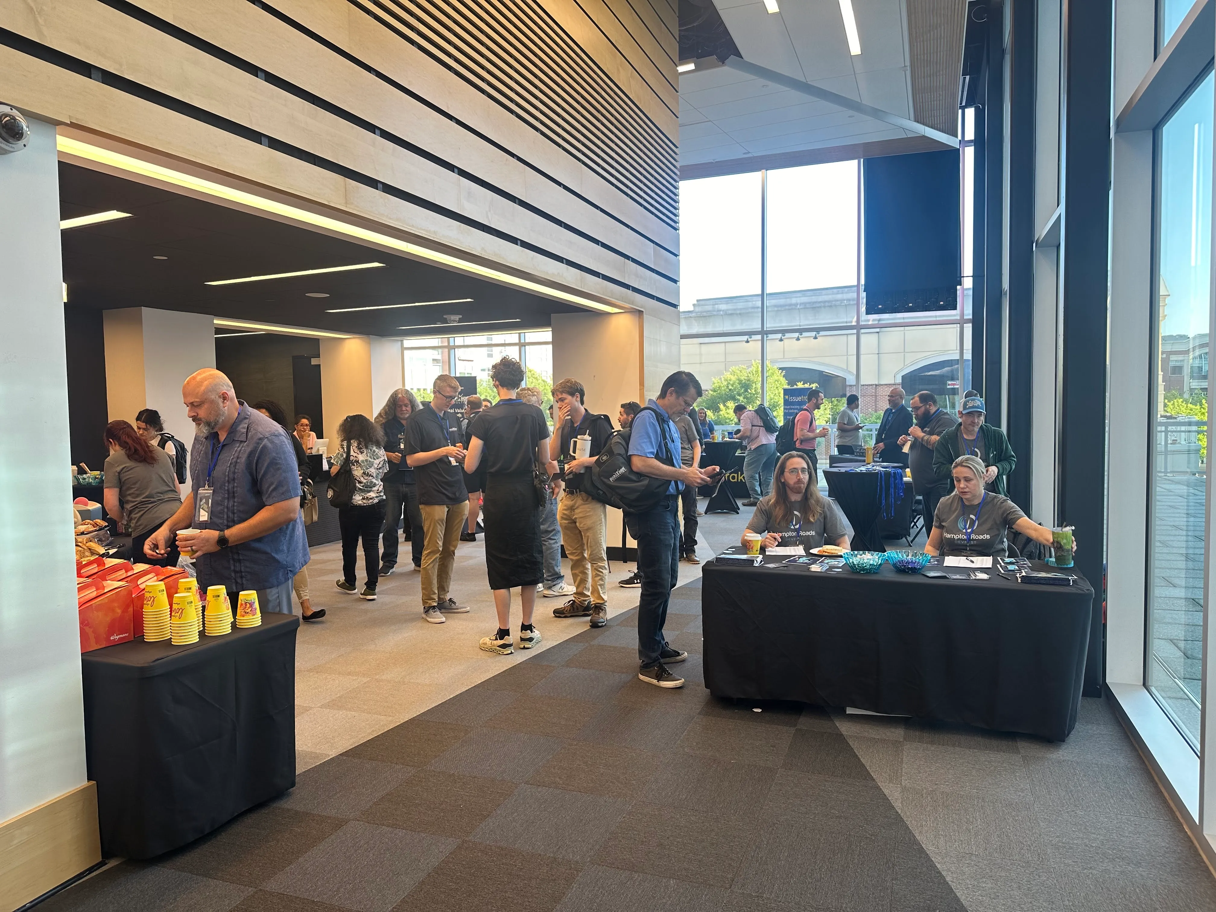 Attendees networking in modern lobby with registration table