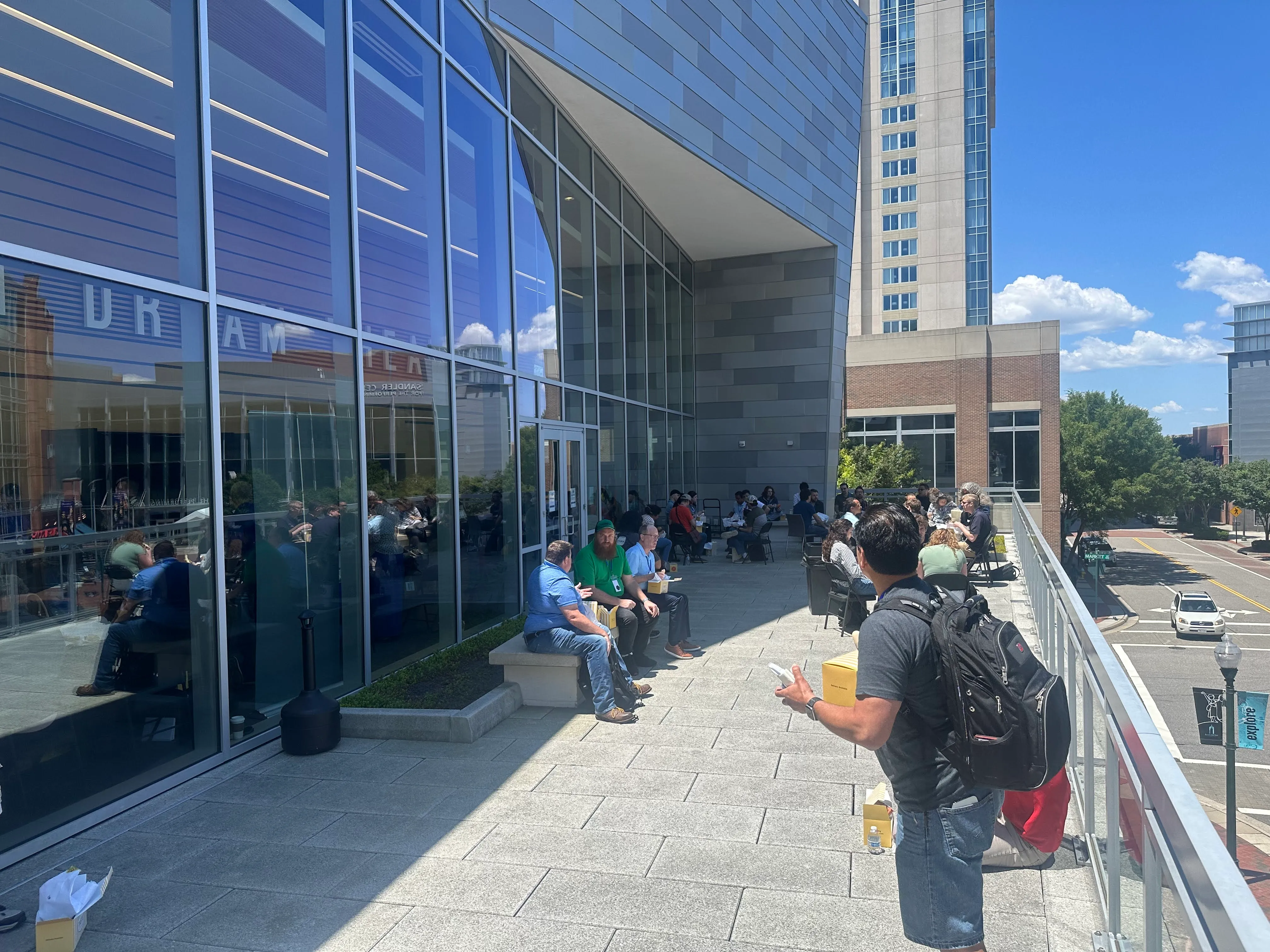 Attendees relaxing on outdoor terrace with city skyline